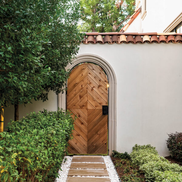 Bask In The Glory Of This Glam Dallas Abode All About The Arches Garden gate and wall with Mediterranean detailing.