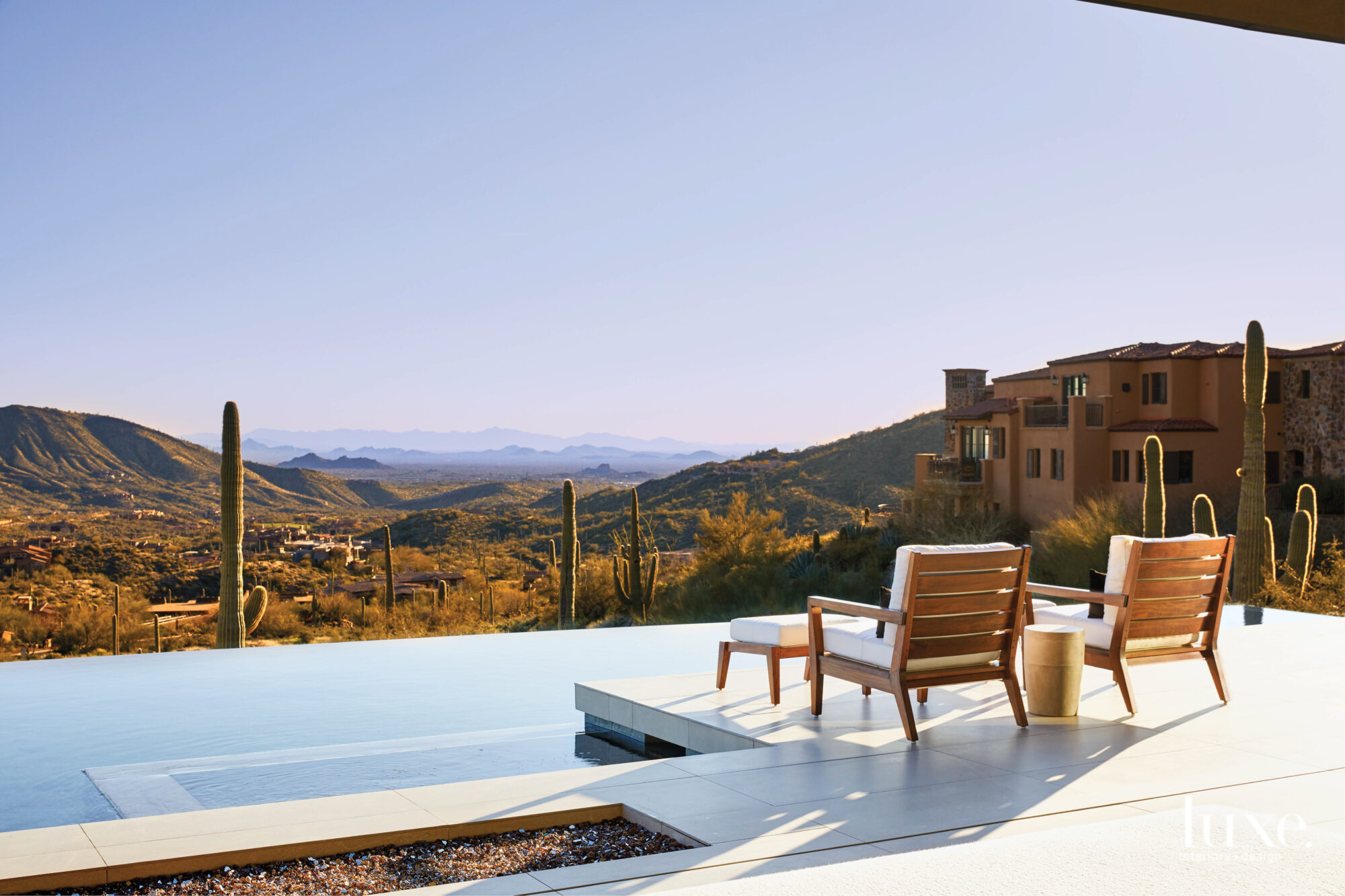 The view from the patio that overlooks an infinity pool and the mountains.