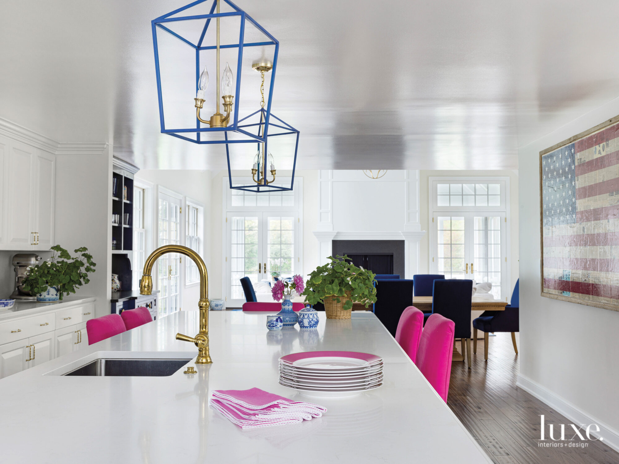 The kitchen has fuchsia counter stools, and blue-and-gold accents throughout.