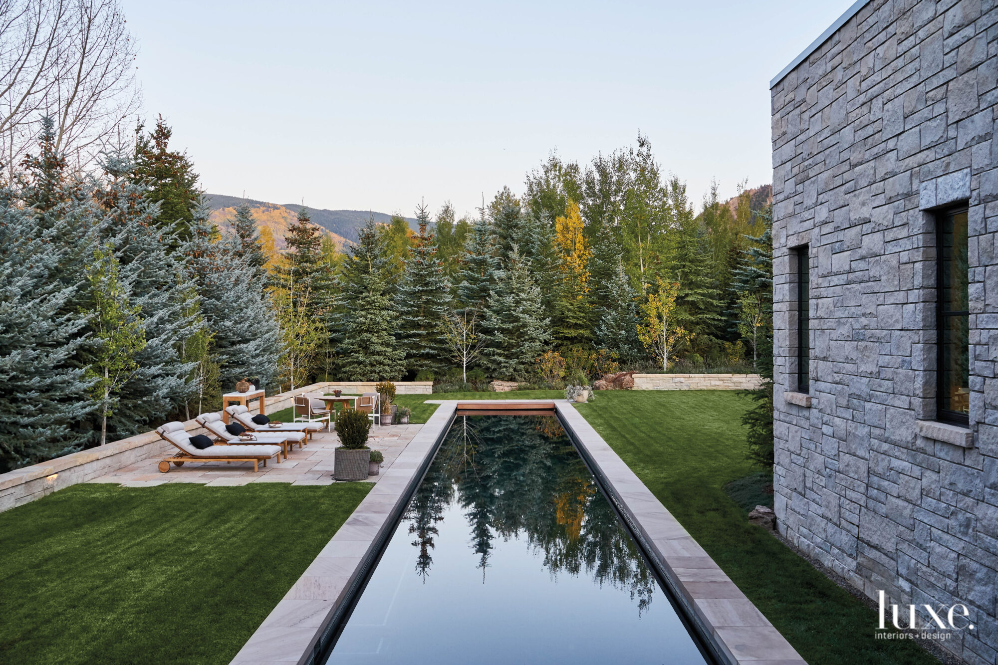 wellness room with long swimming pool stretching into the landscape