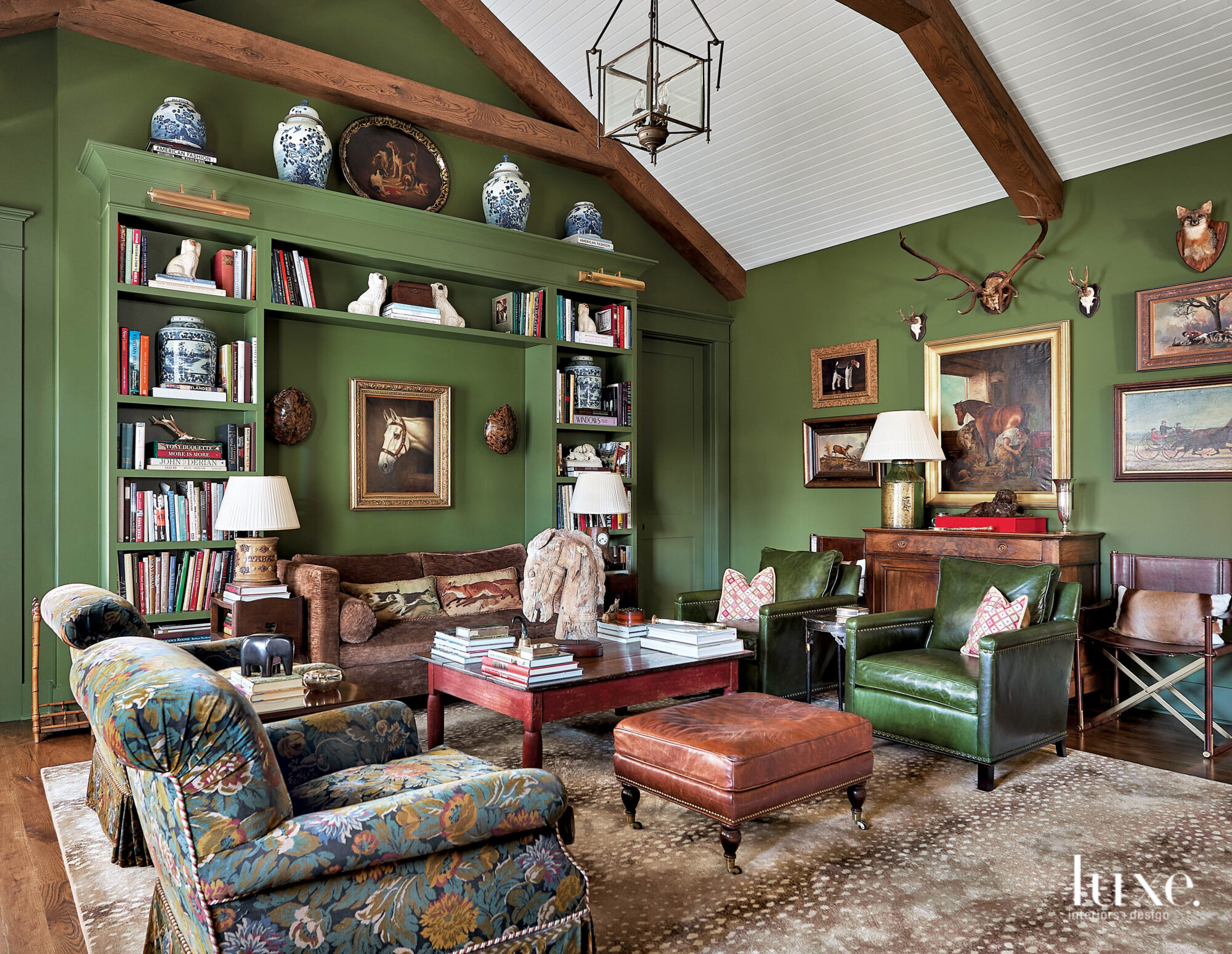 Green library with leather chairs and ottoman