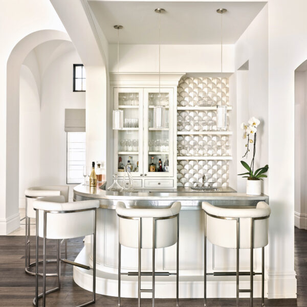 Embracing The Frontier Spirit And Charms Of Arizona Living The all-white bar area has custom millwork and upholstered stools.