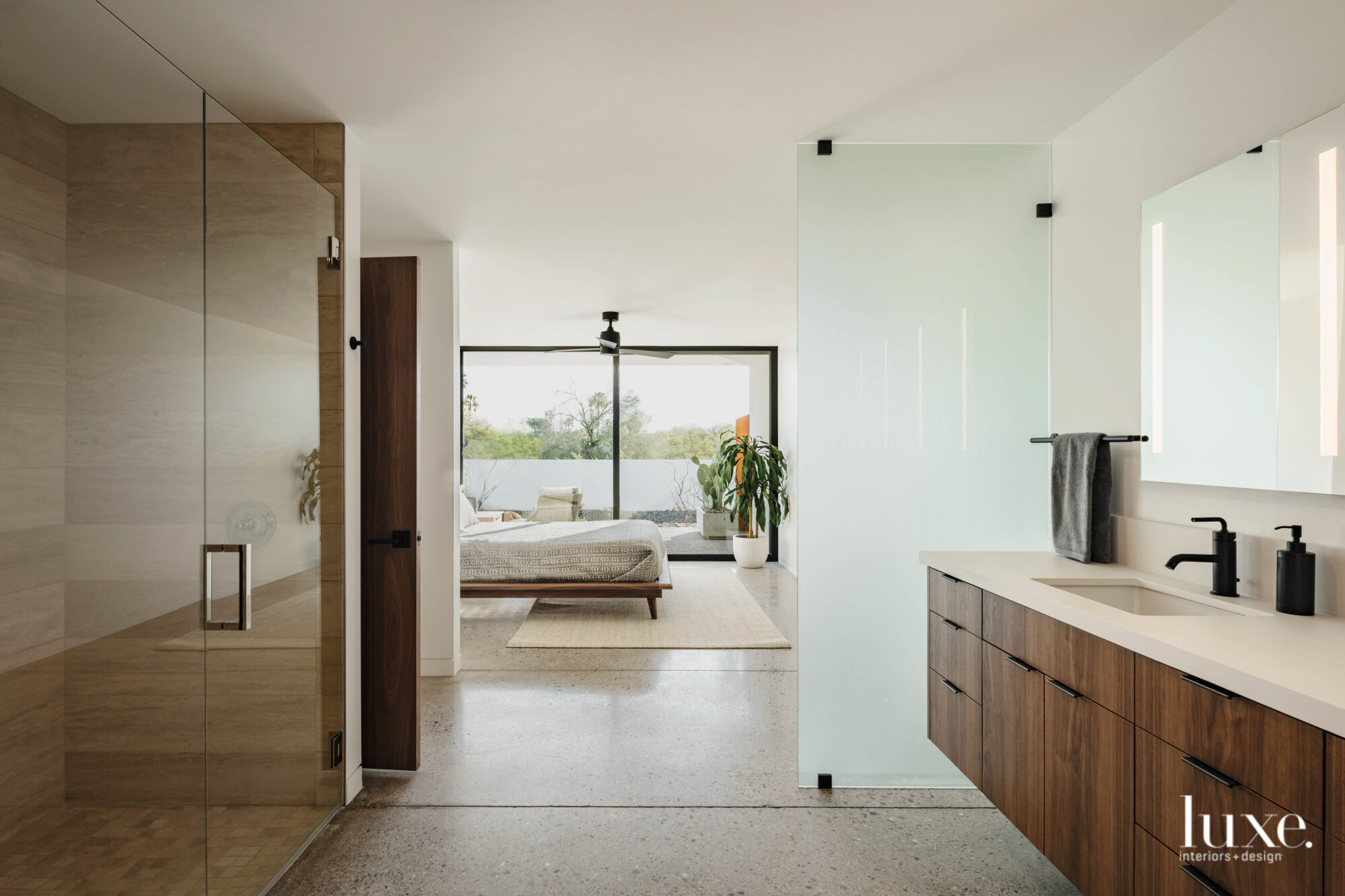 The in-law suite has an open plan bedroom and en-suite bathroom with concrete floors.