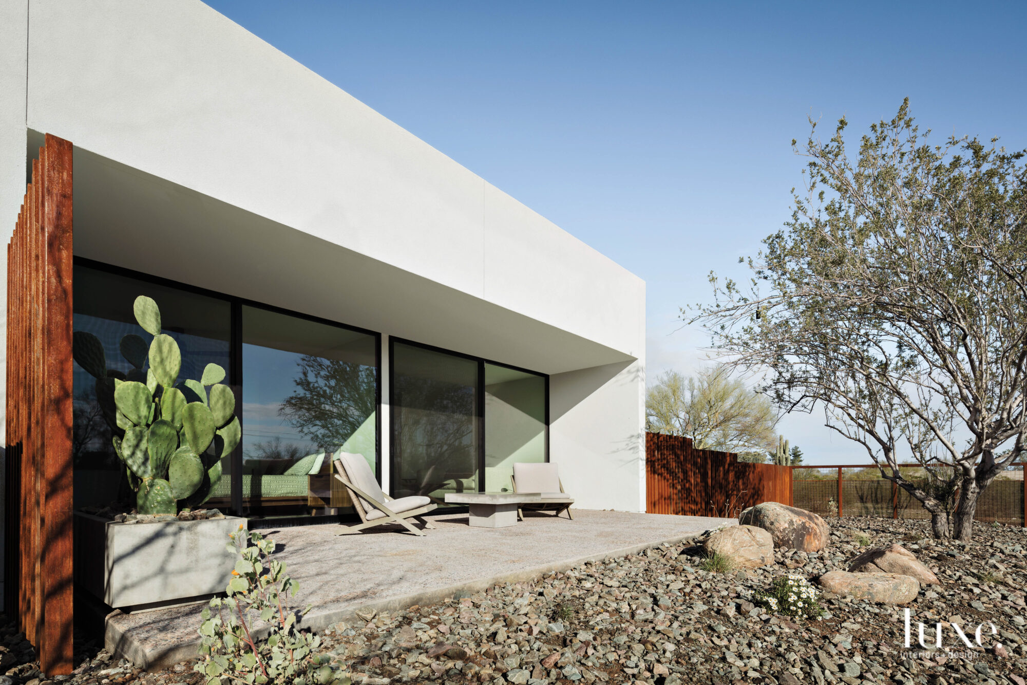 The exterior of the home is comprised of stucco, ipe wood and recessed opening with glass and steel.