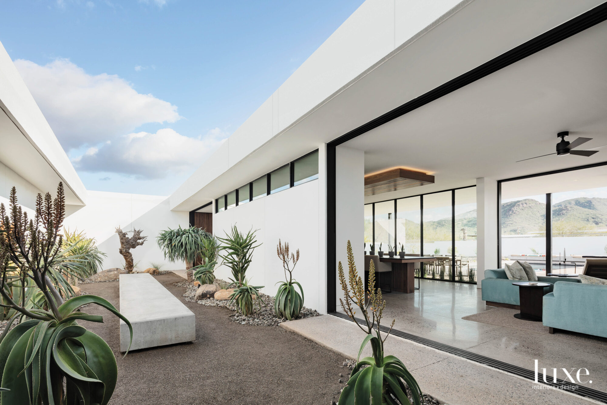 The living room opens up to the courtyard that has native desert plants.