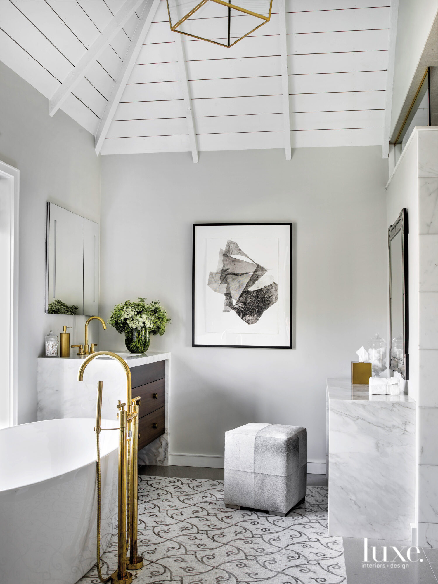 The gray bathroom has a freestanding tub and a shiplap ceiling.