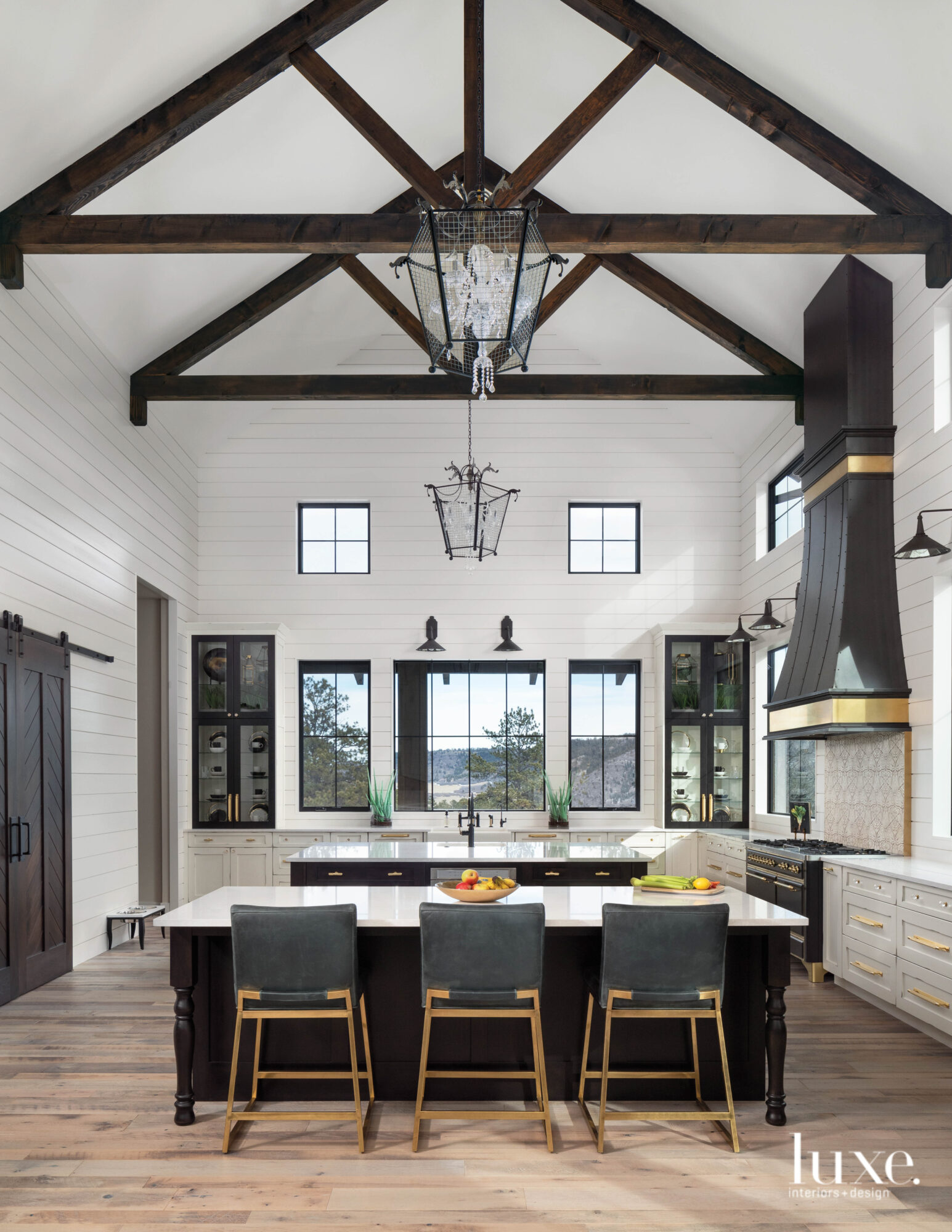 The modern farmhouse kitchen has high ceilings and grand dimensions