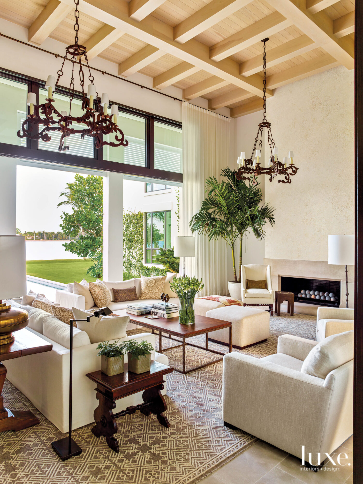 living area with white furnishings and antique chandeliers