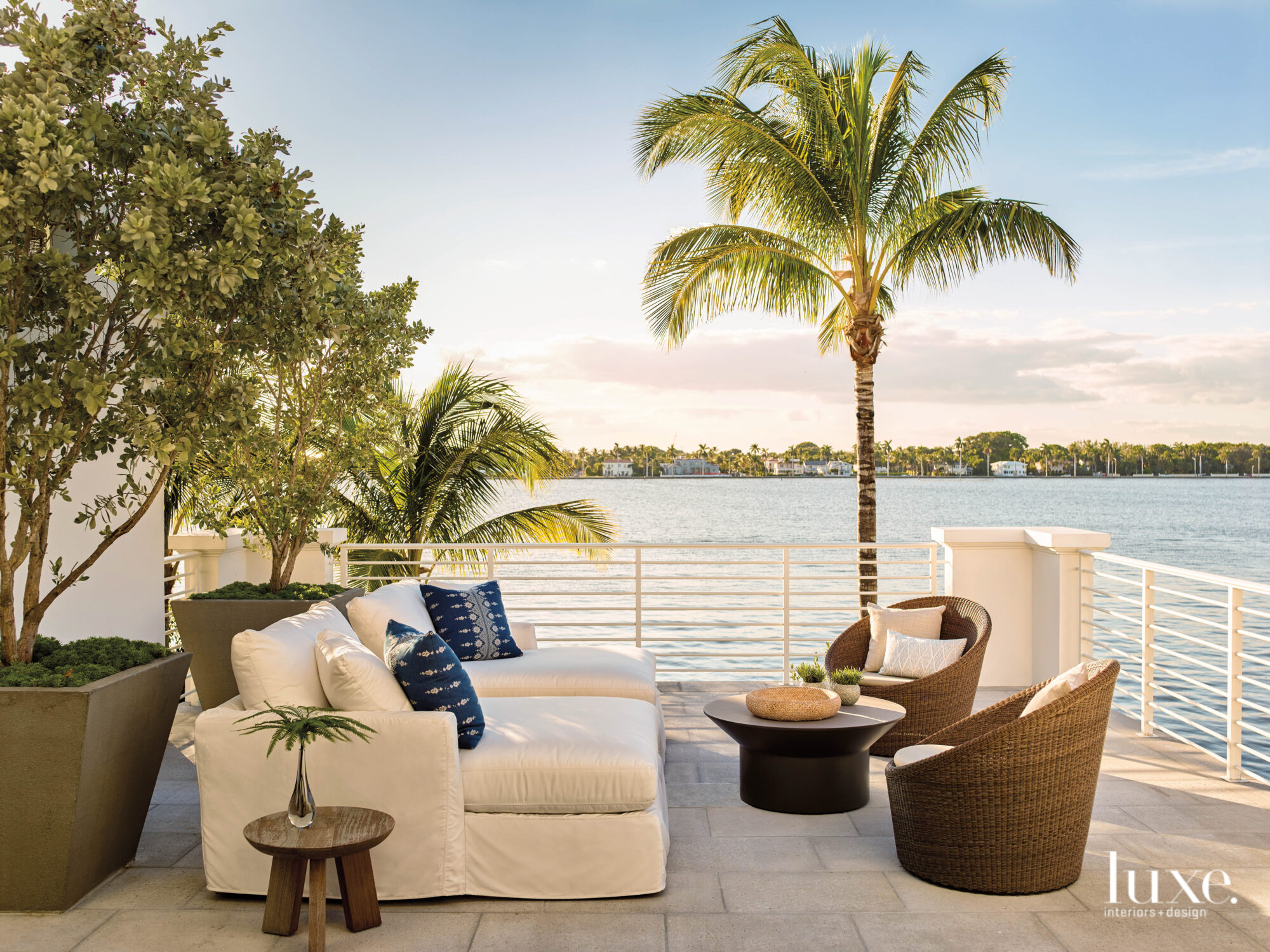 terrace with loveseat and armchairs overlooking water