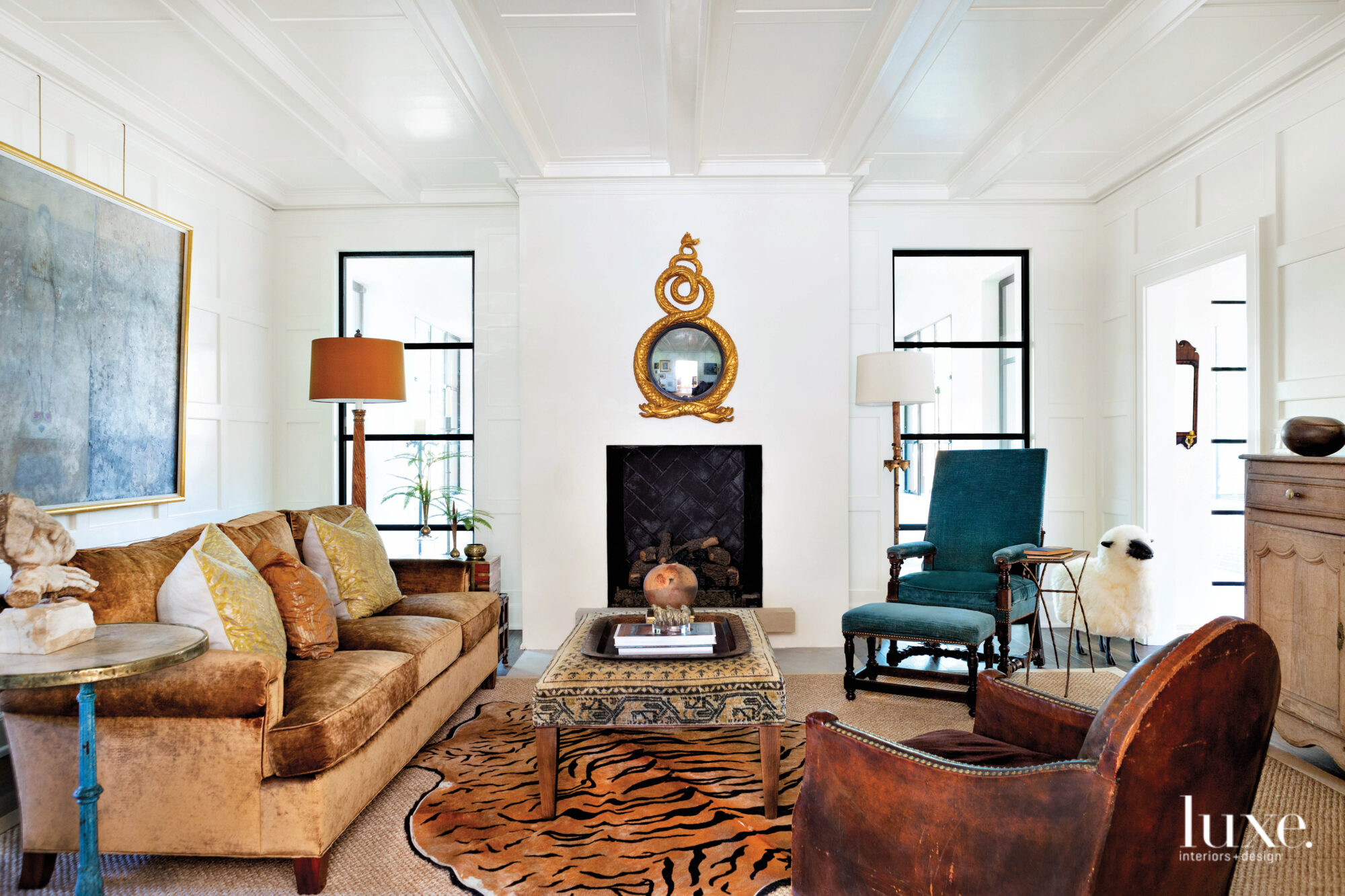 Den with white walls, simple fireplace, convey mirror, tiger-print rug