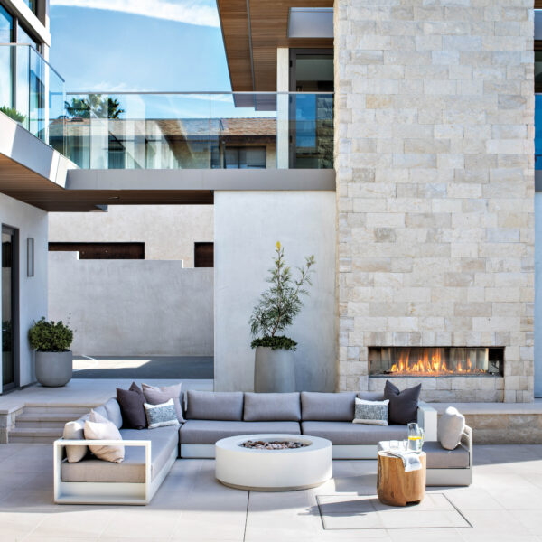 Outdoor terrace with large sectional and fireplace and fire feature