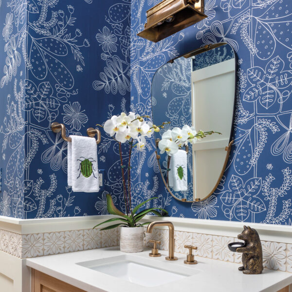 For A Denver Family, An Arts And Crafts-Inspired Home Represents A New Beginning The powder room has a bright blue wallcovering and a brass light fixture.