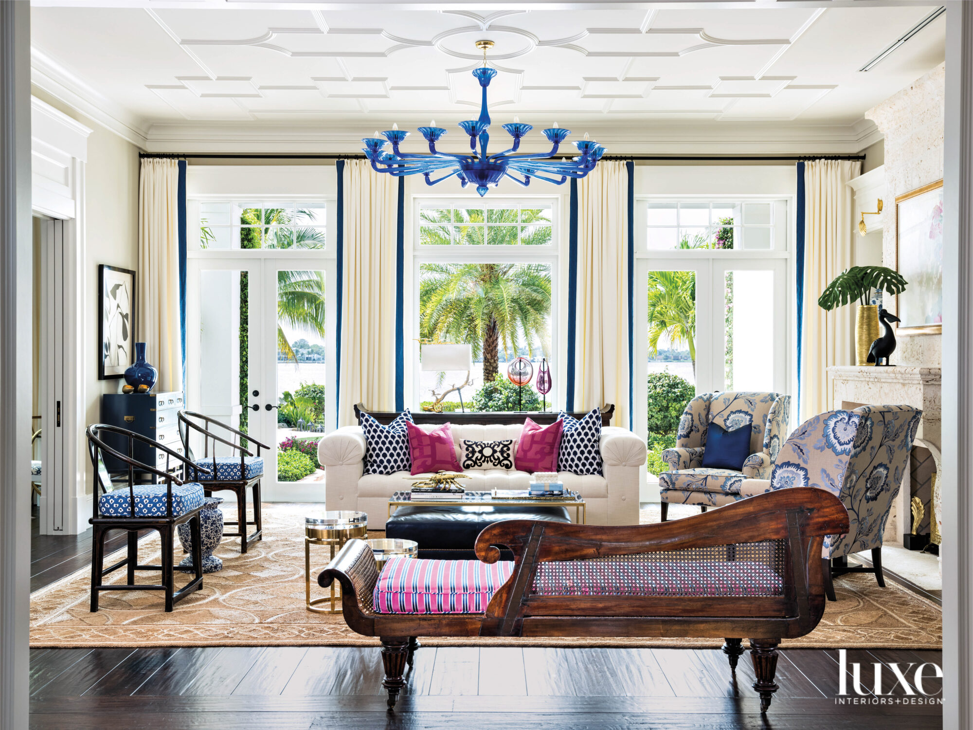 formal living room with blue murano chandelier, a daybed and armchairs