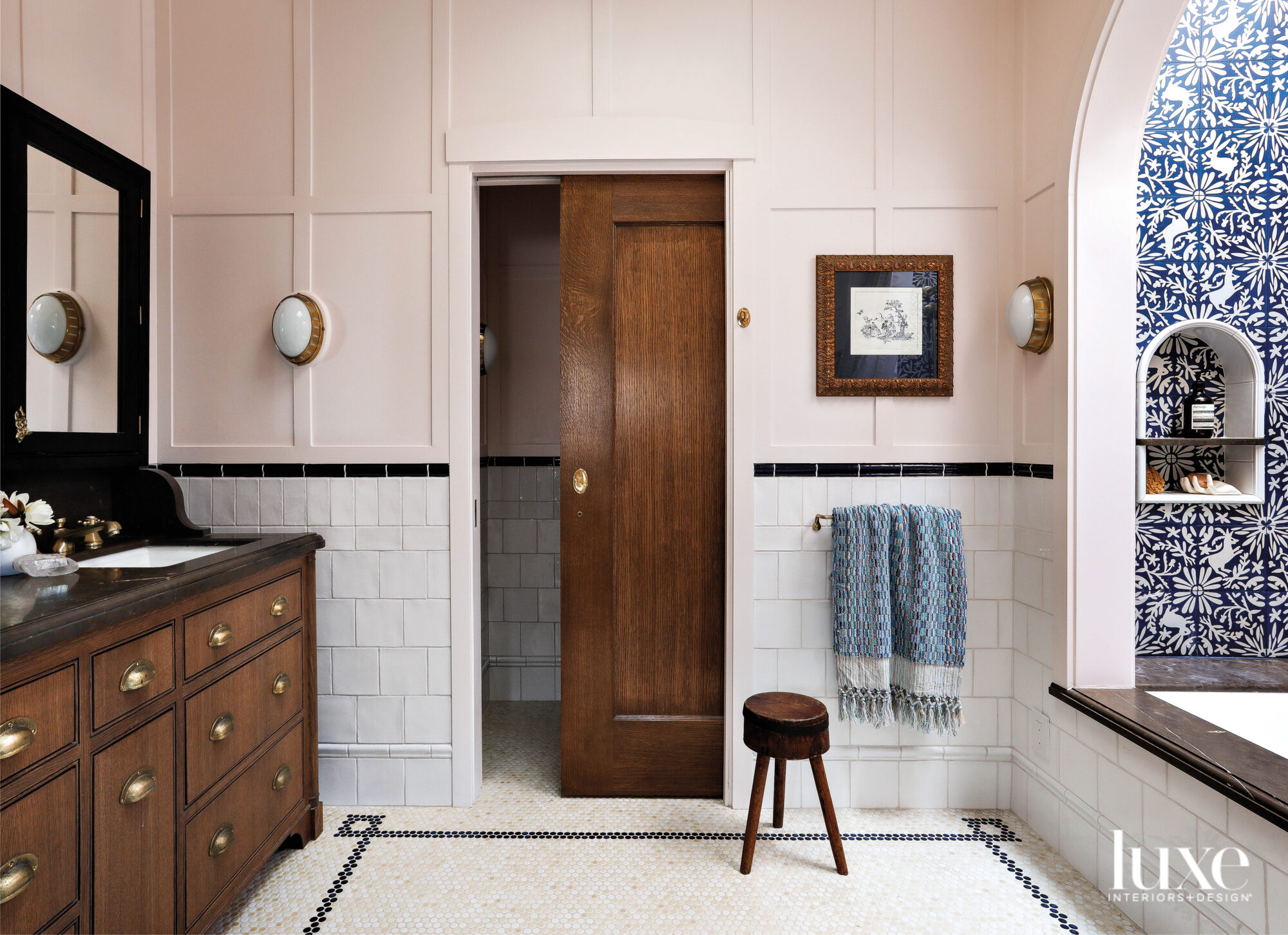 The master bathroom has light pink walls and white tile.