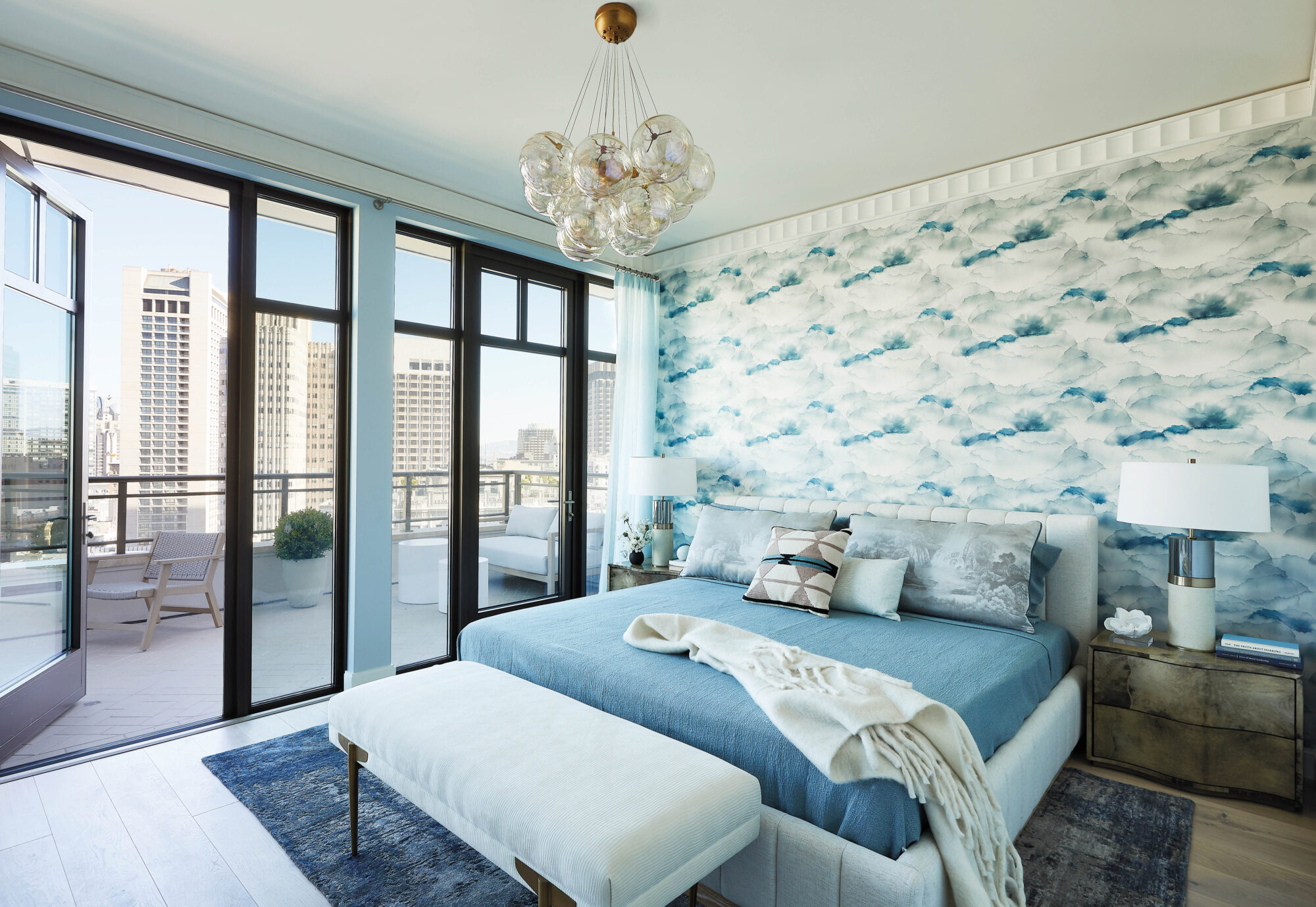 bedroom with blue linens and mural