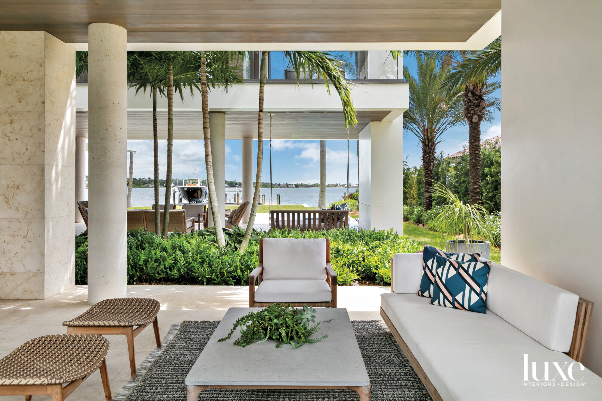 Outdoor living space with lounge chairs, daybed and ottomans.