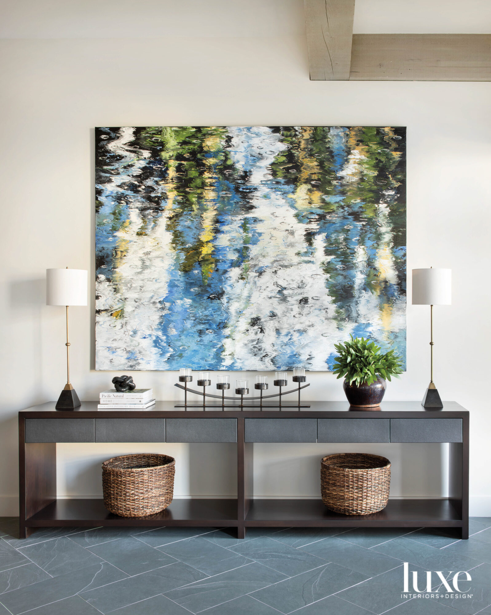 Painting above a long console table with two lamps