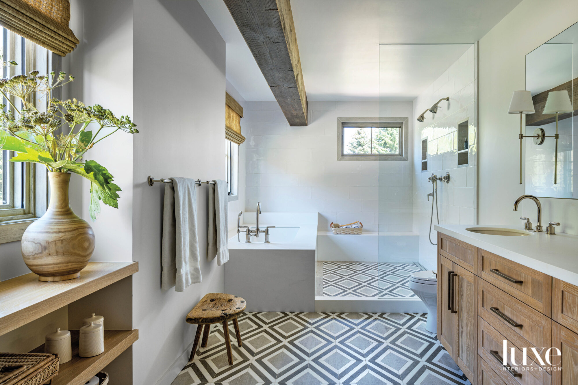 Main bathroom with walk in shower and geometric pattern floor tile
