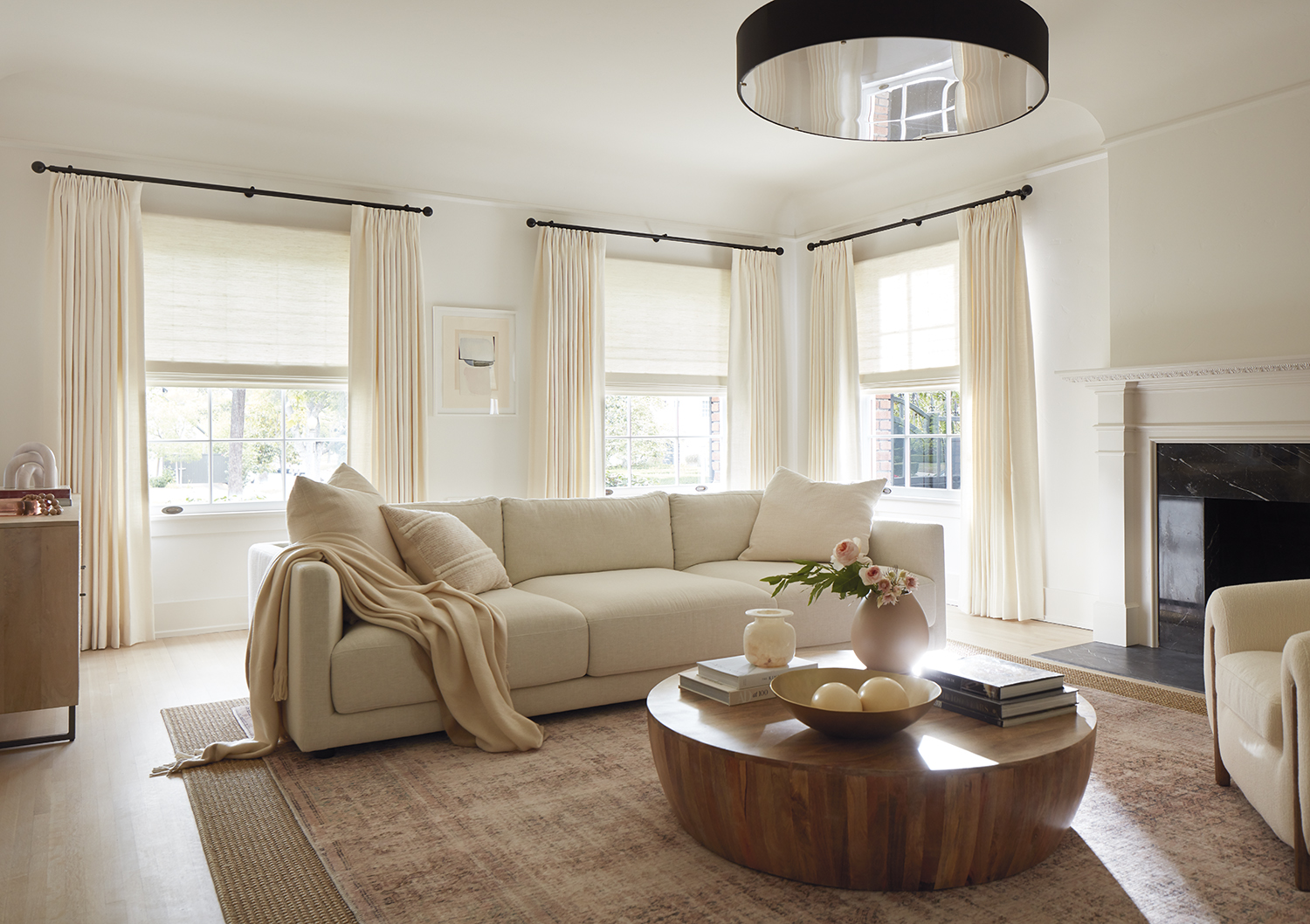 neutral living room with cream curtains and window treatments by gold list sponsor the shade store
