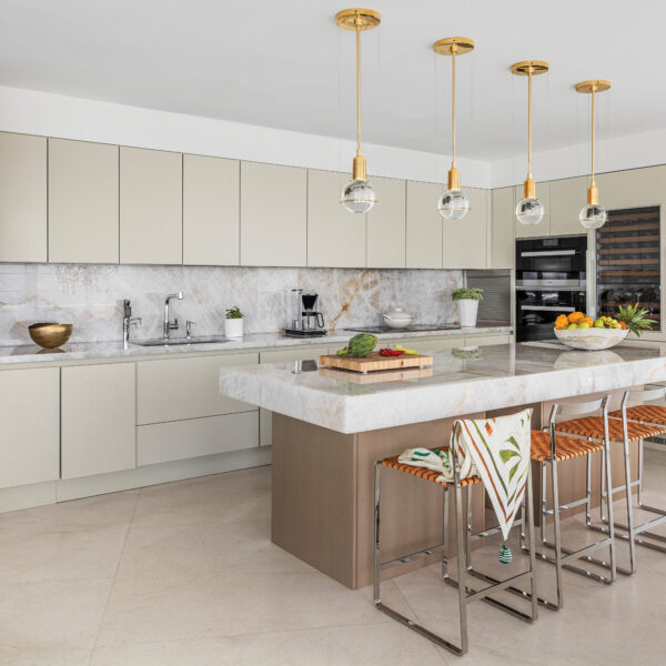 Call It Perfect Harmony: Feng Shui Informs The Design Of A Miami Beach Condo neutral-colored kitchen with island, bar stools and gold globe lights