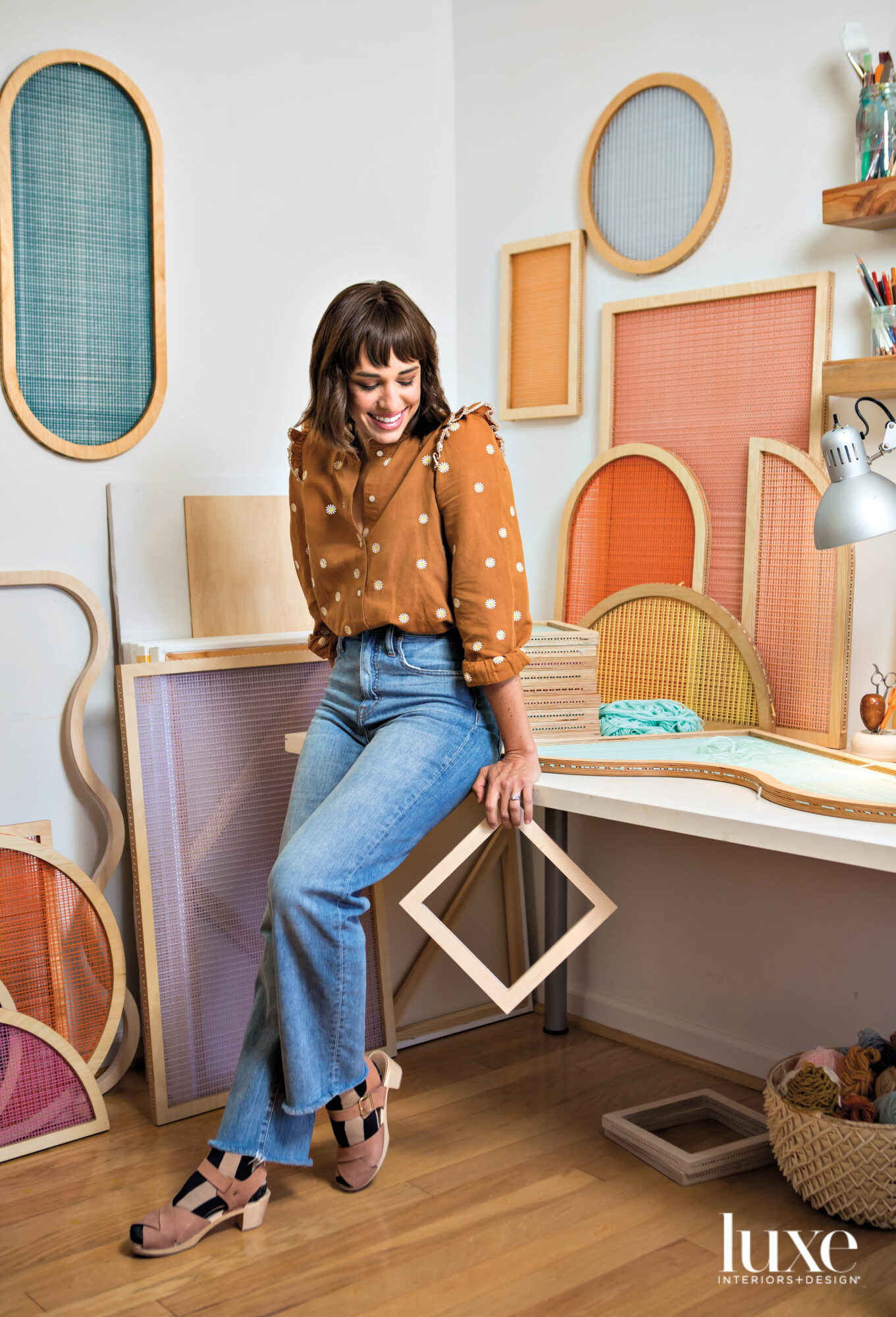 artist Hayley Sheldon poses by her colorful decorative screen works