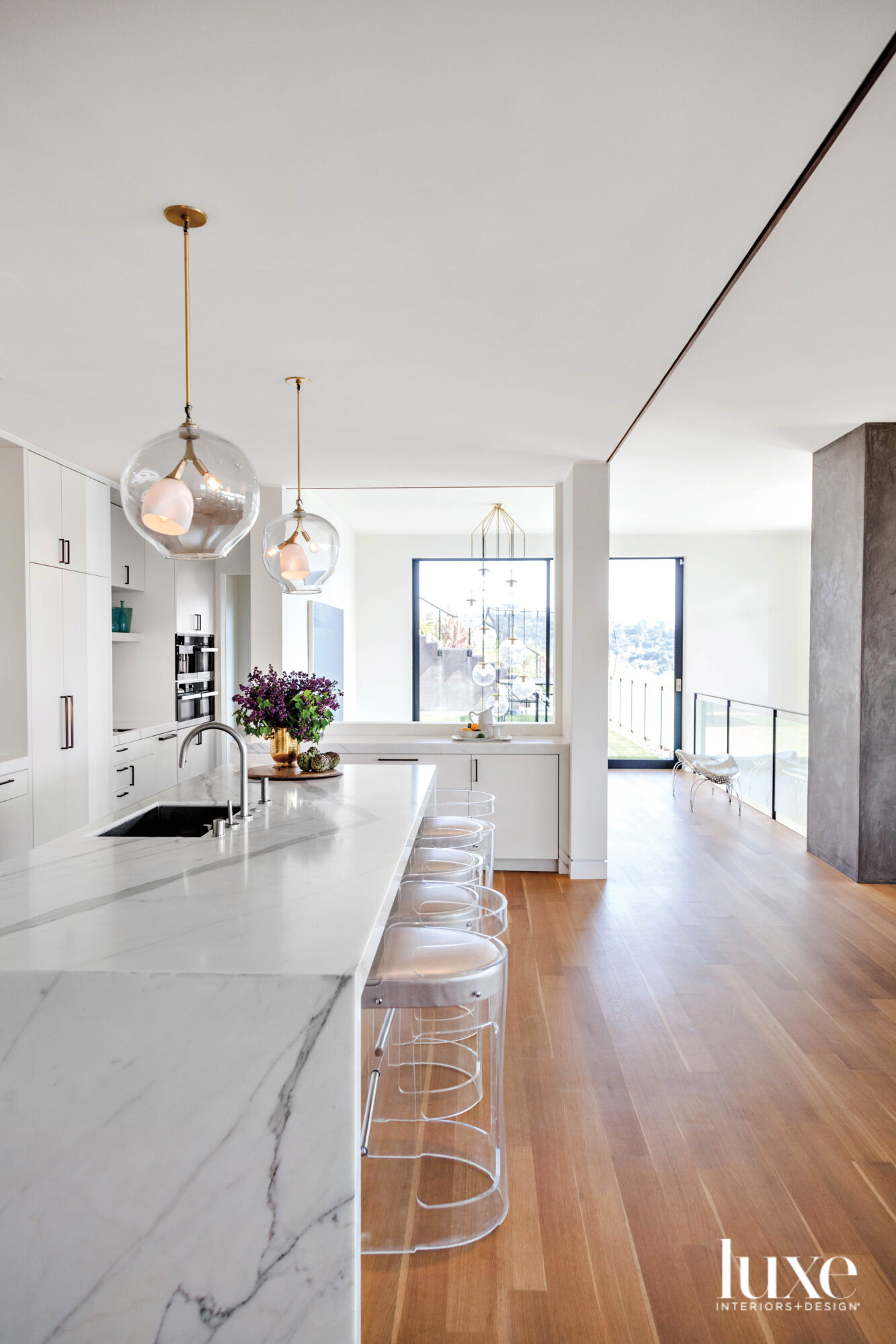 kitchen with calacatta marble island and vintage lucite stools