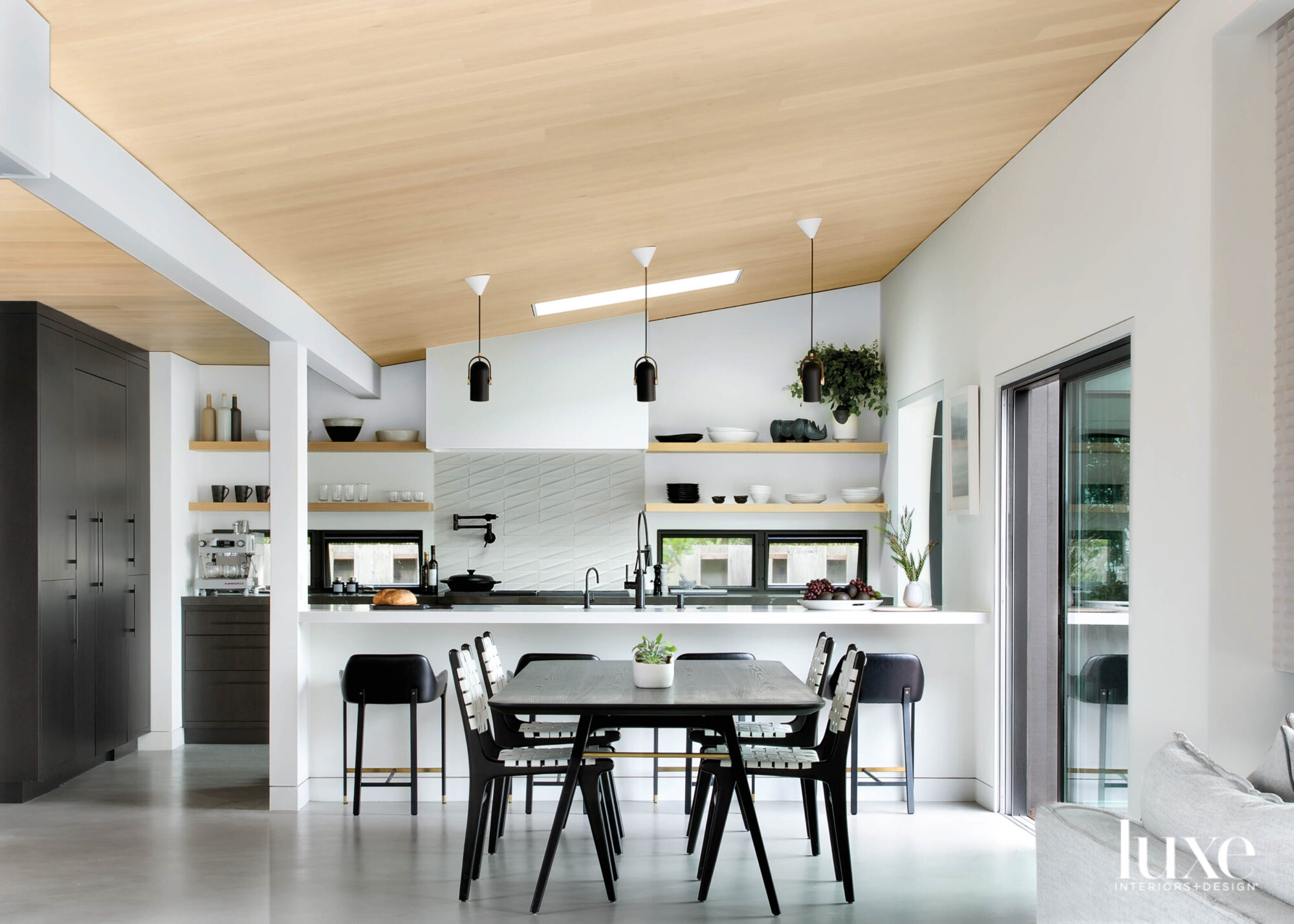 neutral minimalist kitchen with black accents and pattern backsplash