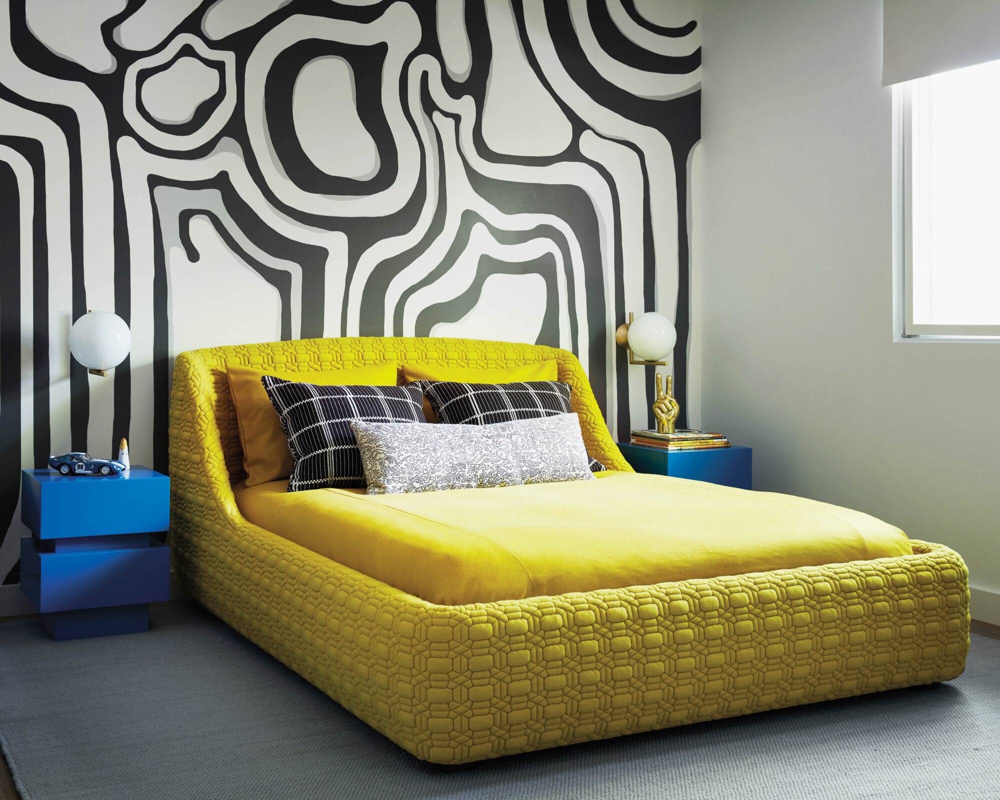 yellow bed with black and white mural