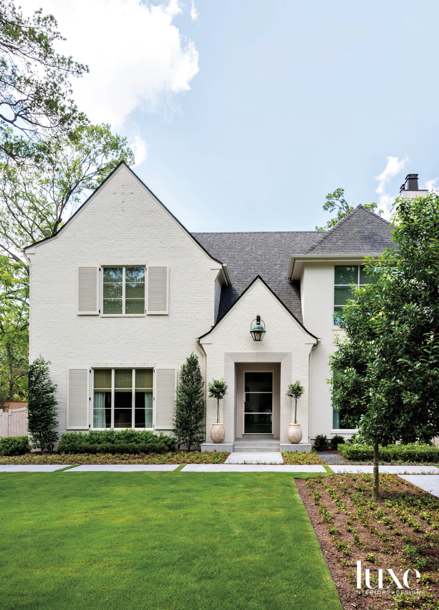 White painted brick home with...