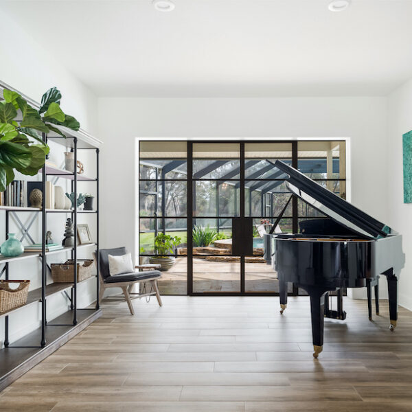 Custom high-performance steel windows and doors with black Frame in a classic living room with baby grand piano by Firerock