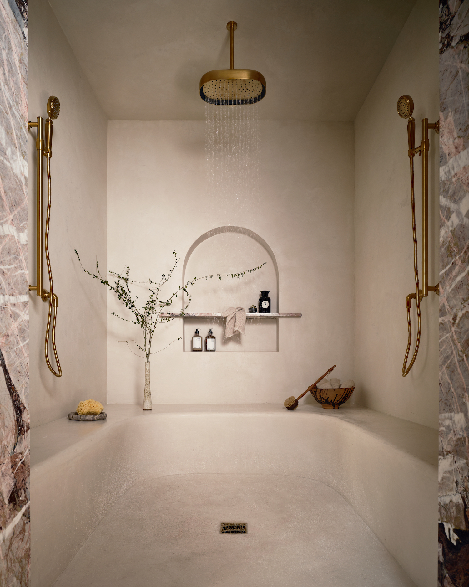 Walk-in master shower with elegant marble design.