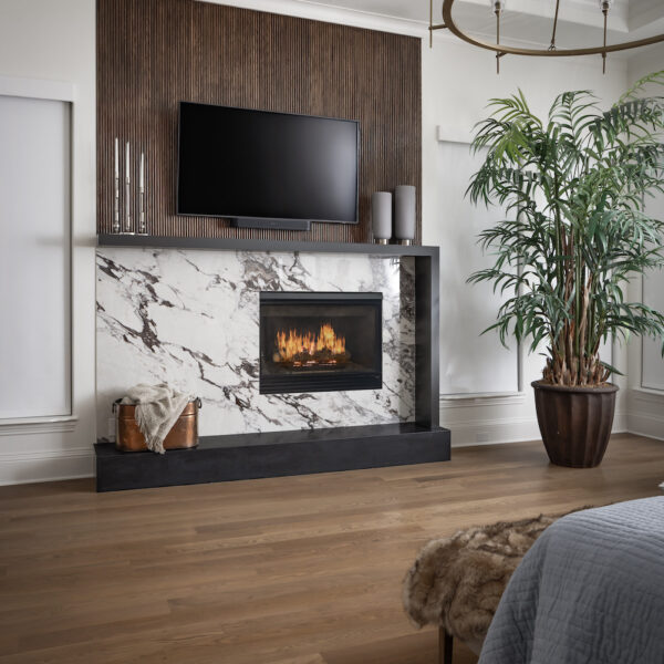 A fireplace in the bedroom with a tv mounted above it.
