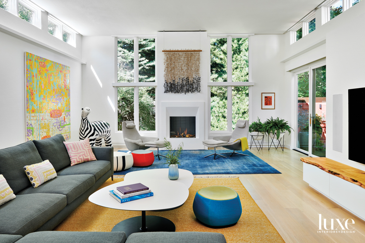 white family room with pops of blue red and yellow designed by Mosaic Architects + Interiors