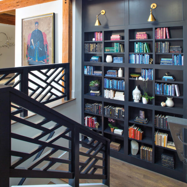 A Bold Colorado Home Shines With A Funky Spin On Cape Cod Charm black stairway with chippendale-style railings and library