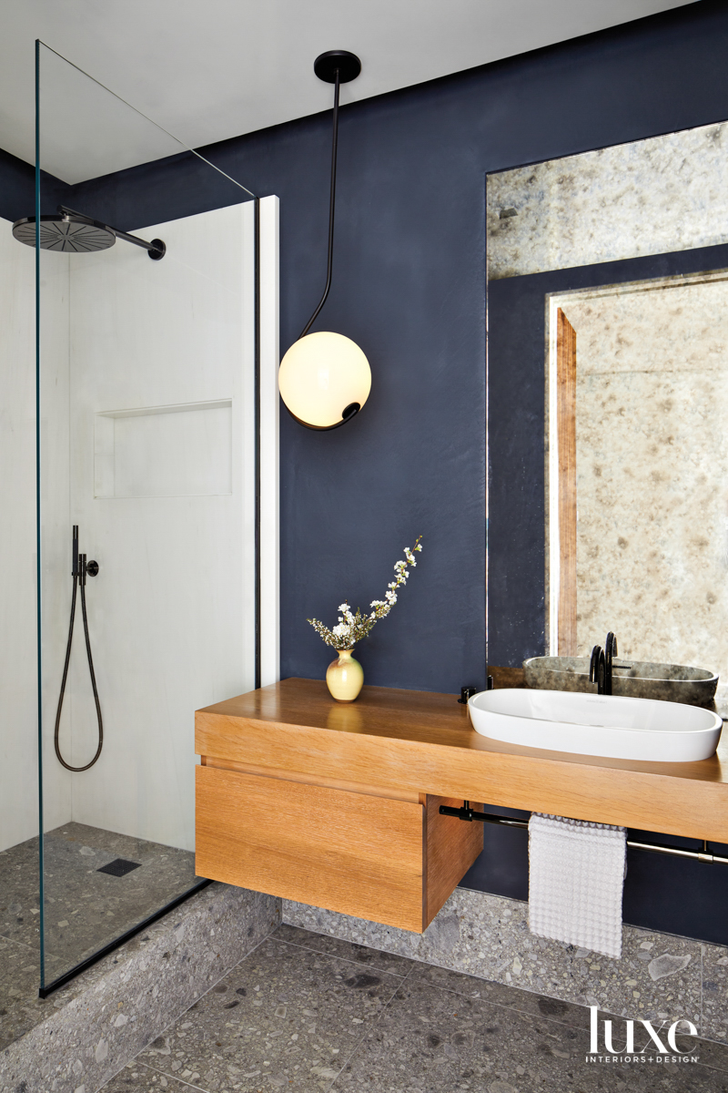 blue plaster bathroom with antique mirror