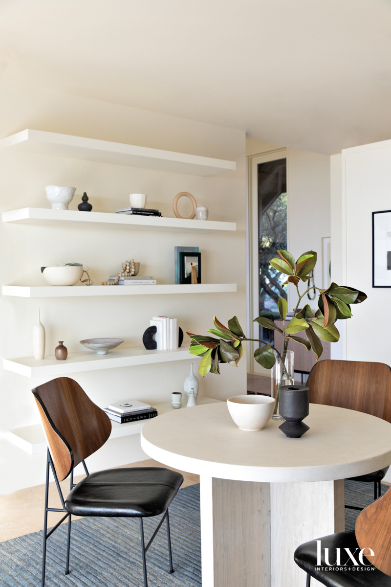 The kitchen's breakfast room gets a modern look with sleek chairs and a table.