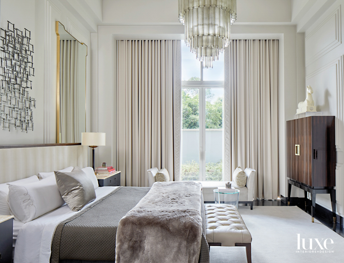 Hotel-like bedroom with glamorous crystal ceiling fixture, fur throw and plush draperies