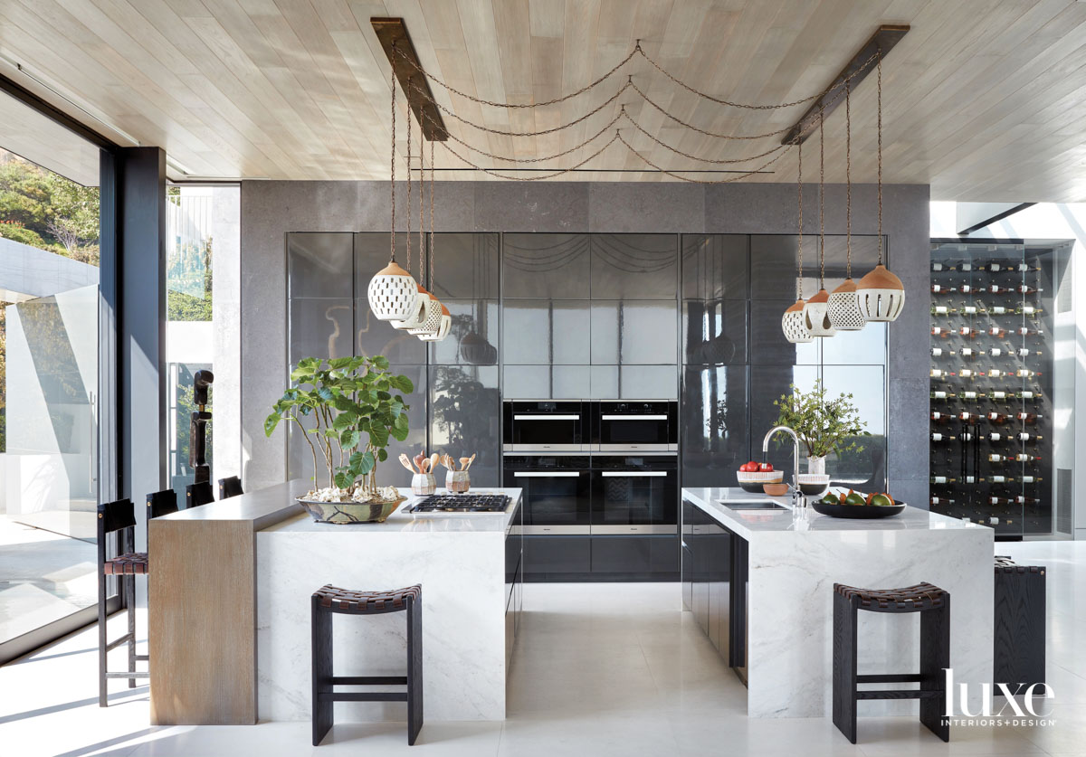 View of kitchen with double islands and ceramic pendants hanging above each
