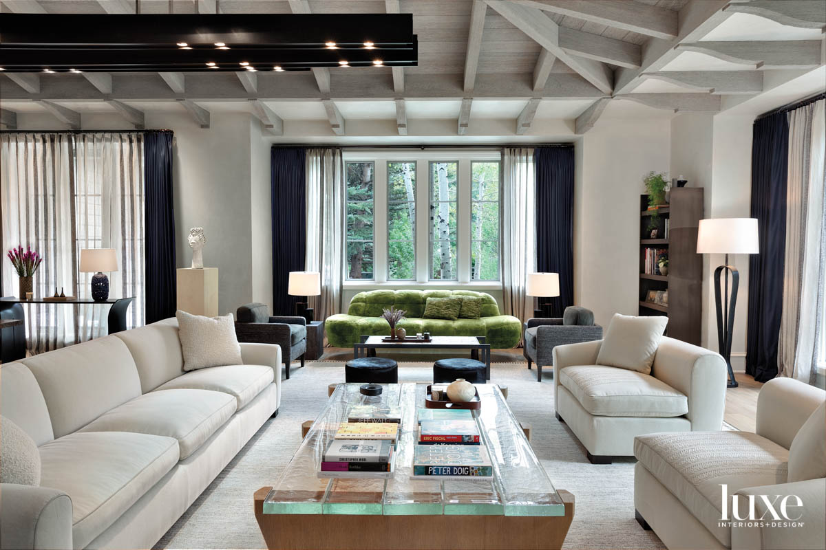 A living room has an industrial light fixture overhead