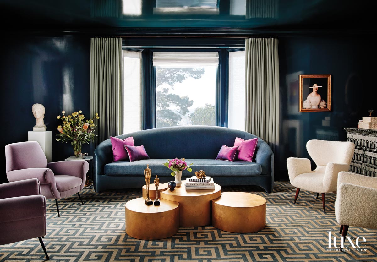 A living room has dark blue walls.