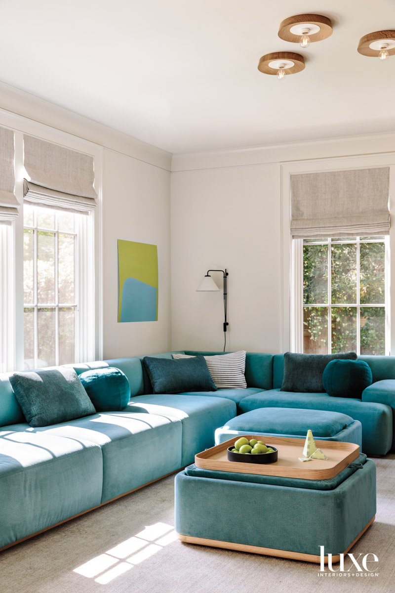 A family room has a large, blue sectional.