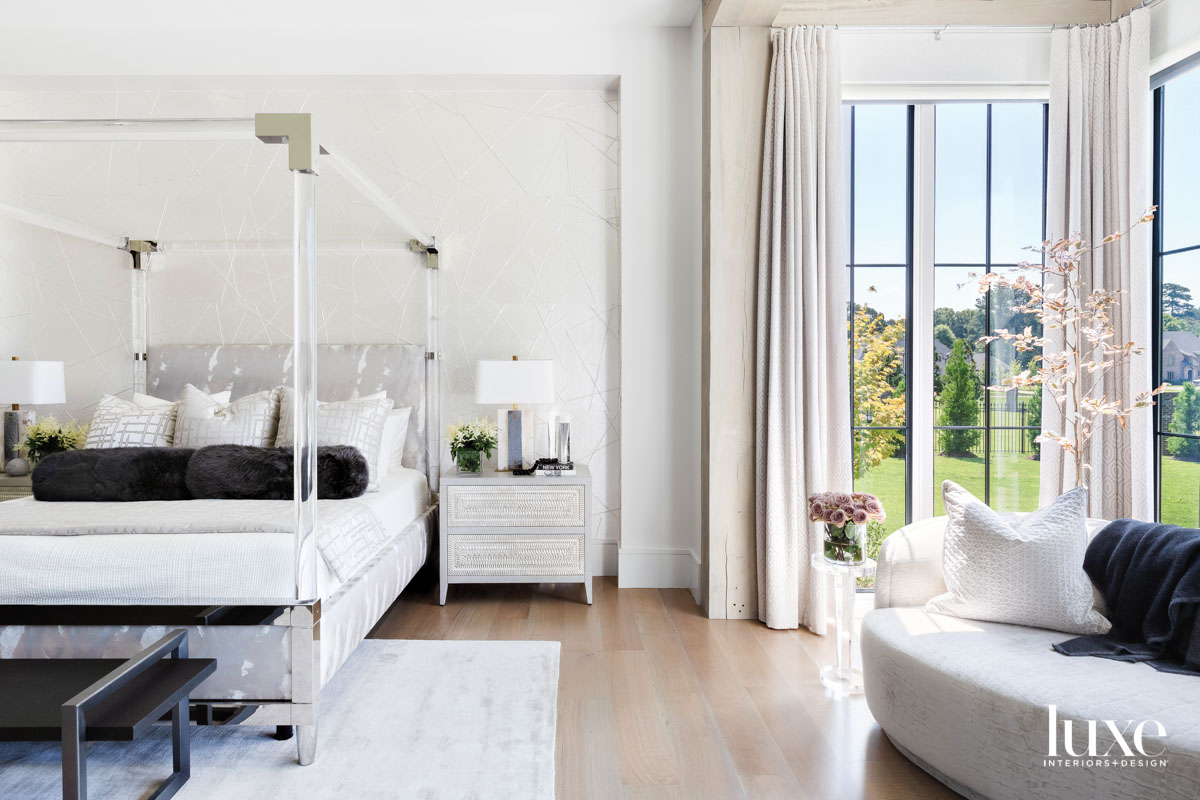 Light-filled bedroom with transparent canopy bed and large window nook