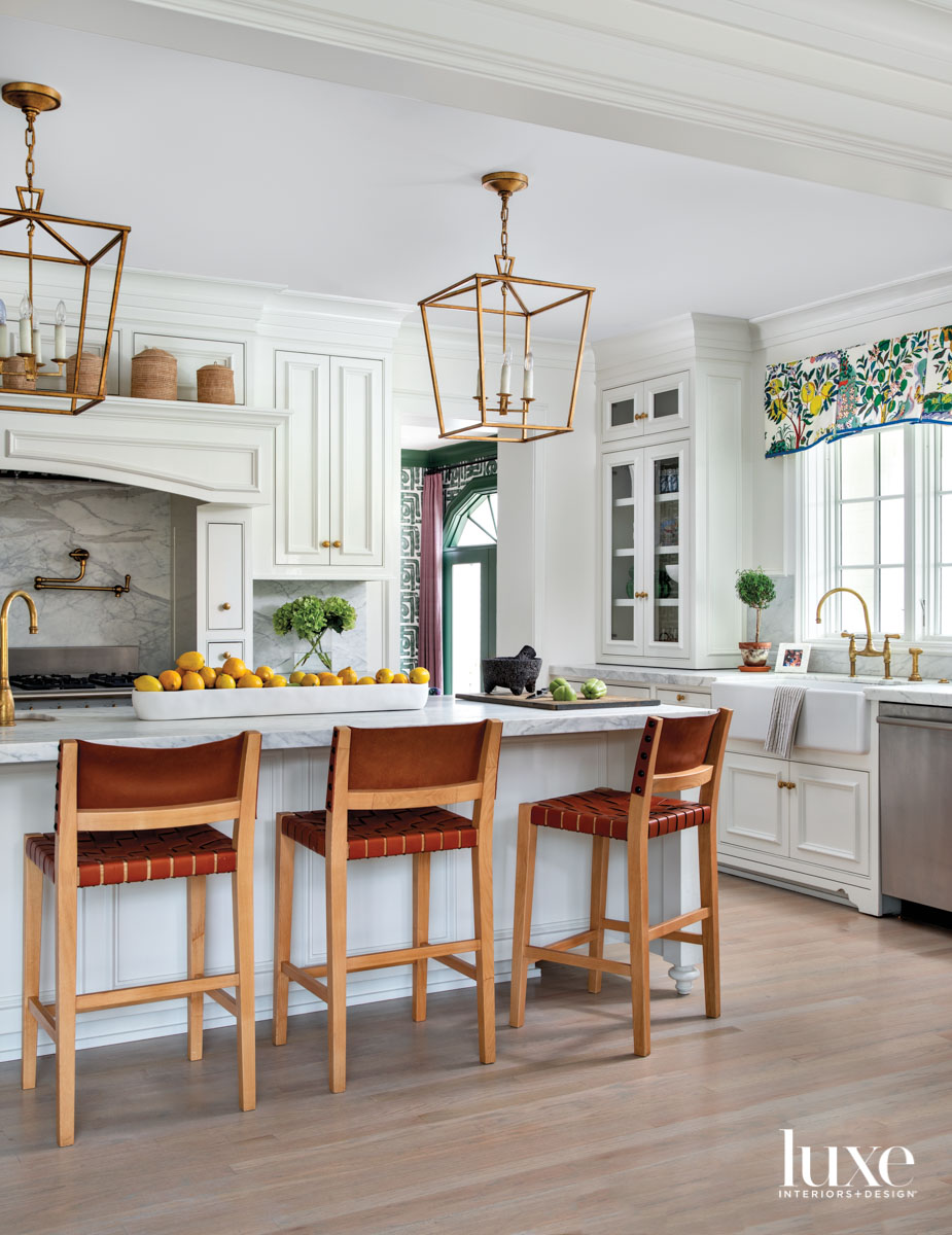 Classic white kitchen with pops of pattern and statement counter stools
