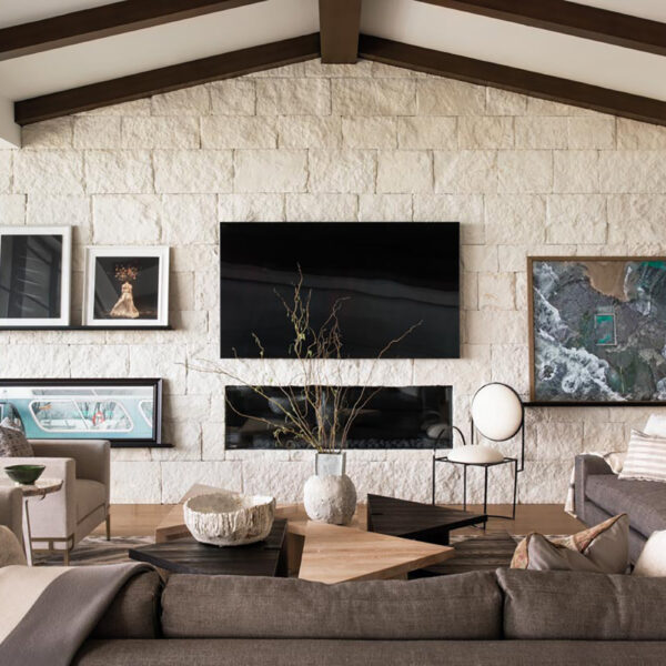 The Artful O.C. Beach Home That Masters A Perfectly Non-Beachy Look modern living room with wall art and exposed stone