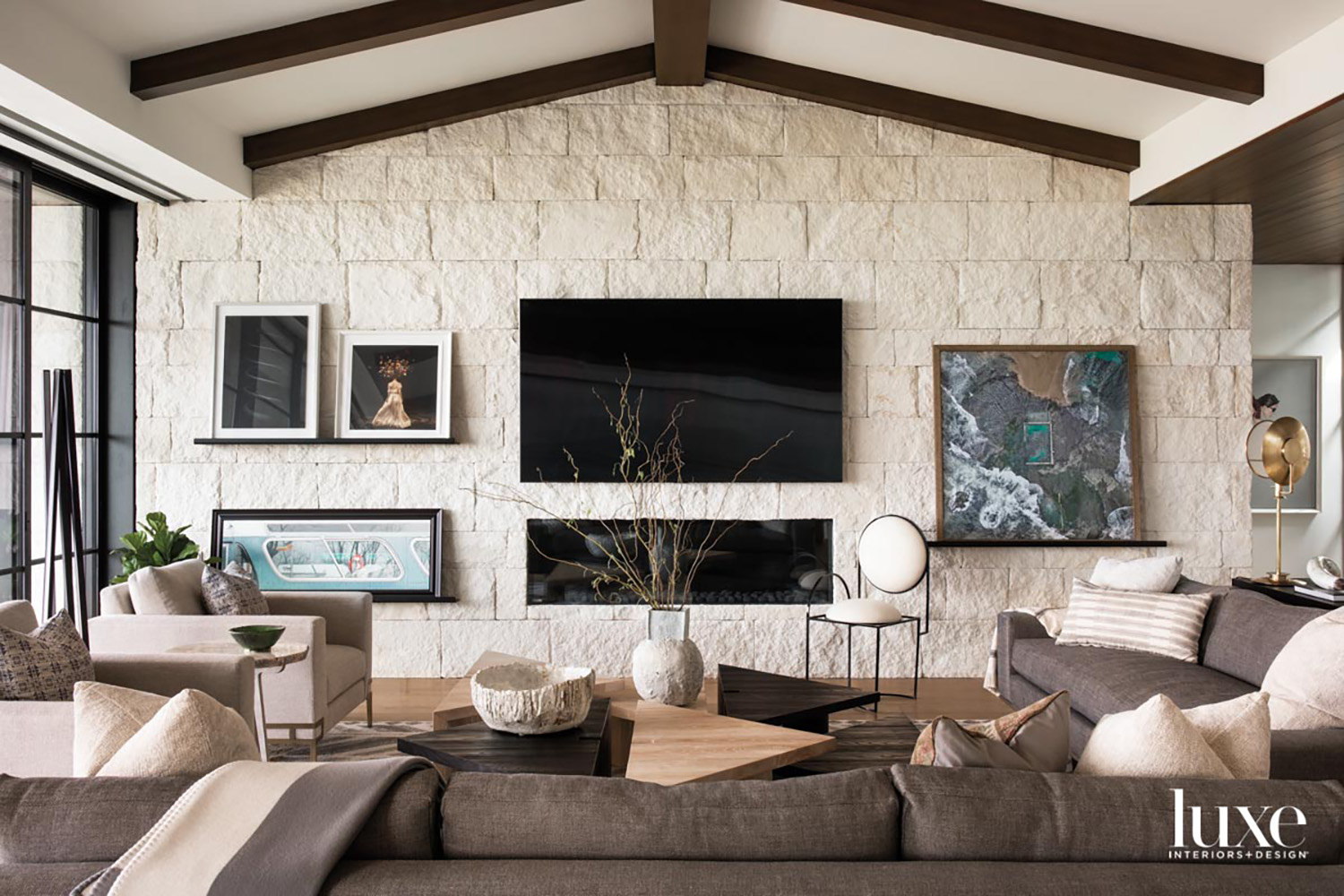 modern living room with wall art and exposed stone