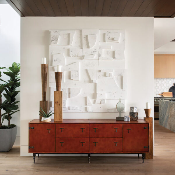 The Artful O.C. Beach Home That Masters A Perfectly Non-Beachy Look modern living space featuring leather cabinet and multi-media wall art