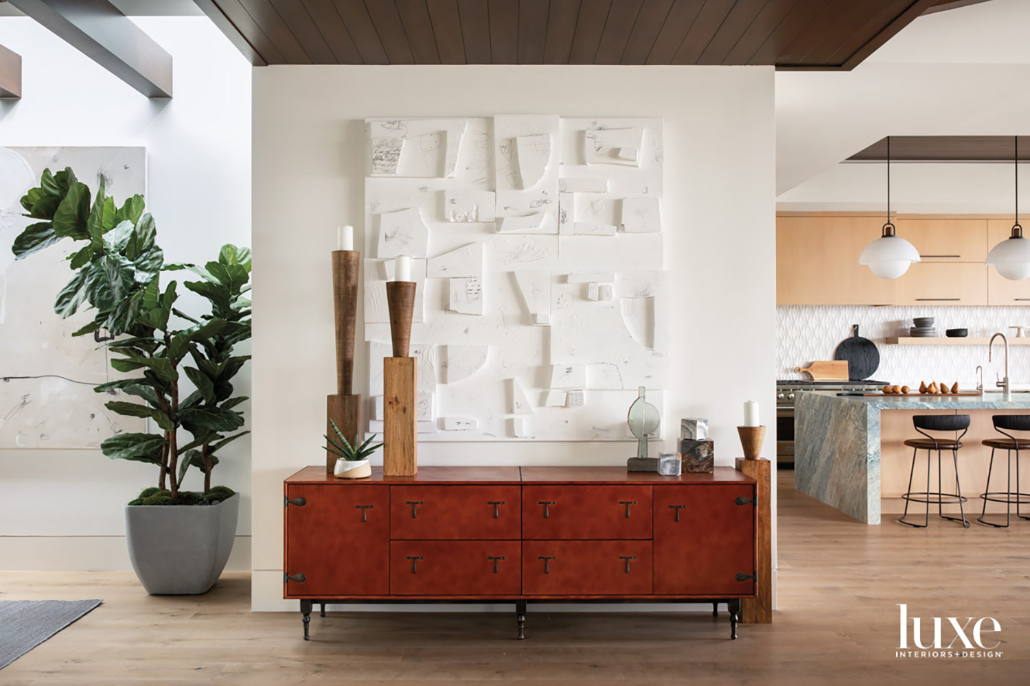 modern living space featuring leather cabinet and multi-media wall art