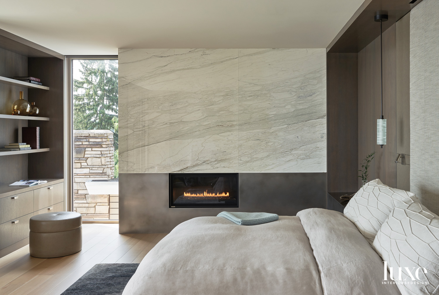 Peaceful zen bedroom design with bed and fireplace shown