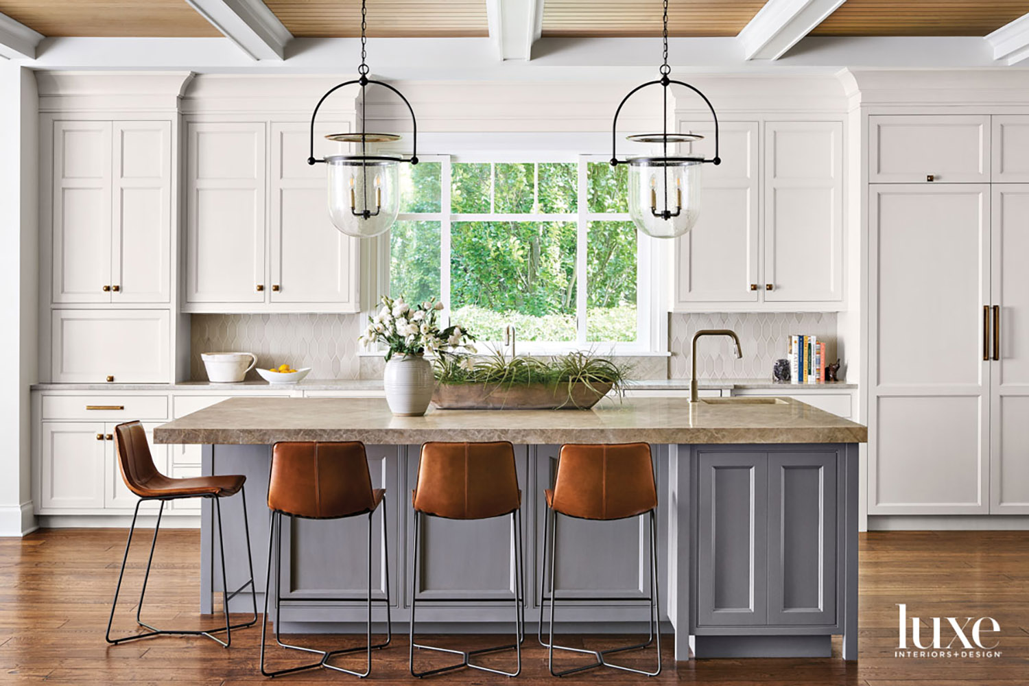 transitional gray kitchen island topped...