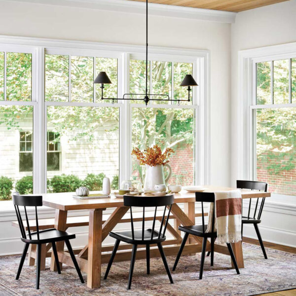 A Wilmette Home Delivers On A Wish For A More Laid-Back Lifestyle transitional dining room with wood dining table and multicolored carpet